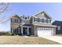 Attractive two-story home with brick and siding, complemented by black shutters at 6199 N Caraway Dr, McCordsville, IN 46055
