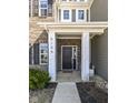 Close-up of the front door with address, decorative columns, and neat landscaping at 6199 N Caraway Dr, McCordsville, IN 46055