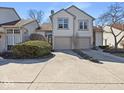 Charming two-story home with attached two-car garage and well-maintained landscaping during daytime at 6263 Behner Way, Indianapolis, IN 46250