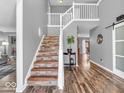 Open foyer showcasing hardwood floors, staircase with wood risers and gray walls at 6620 Avalon Blvd, Avon, IN 46123