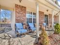 Relaxing front porch with comfortable seating, brick accents and a quaint garden at 6620 Avalon Blvd, Avon, IN 46123