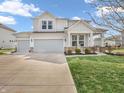 Two-story home with white siding, a well-manicured lawn, and a three car garage at 6915 Diamondleaf Way, Brownsburg, IN 46112