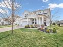 Two-story home with gray siding, white trim, a well-manicured lawn, and a three car garage at 6915 Diamondleaf Way, Brownsburg, IN 46112