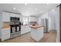Well-equipped kitchen with stainless steel appliances, white cabinets, and butcher block countertops at 721 E Morris St, Indianapolis, IN 46203