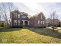 Attractive brick home with a neat front lawn and mature trees adding to its curb appeal at 7239 Bellini Ln, Indianapolis, IN 46259