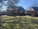 The backyard has a pergola attached to a detached garage and mature trees at 730 E Main St, Plainfield, IN 46168
