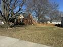 Brick home with lawn and privacy fence that enhances the property's outdoor appeal and security at 730 E Main St, Plainfield, IN 46168