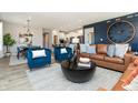 Comfortable living area with stylish furniture, a statement wall, and an open layout to the kitchen at 7572 Bluegill Dr, Noblesville, IN 46062
