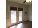 Bright room with french doors leading to the outside with wood-look flooring, and chair-rail detail at 7625 Partridge Rd, Indianapolis, IN 46227