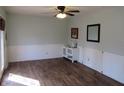 Bright room with a door to the exterior, complemented by wood-look flooring, and chair-rail detail at 7625 Partridge Rd, Indianapolis, IN 46227