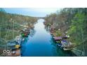 Scenic aerial view of the lake showcasing waterfront homes with private boat docks at 8205 Bass Dr, Nineveh, IN 46164