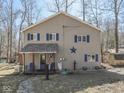 Charming two-story home featuring a covered porch, American flag, and a decorative star at 8460 S Green Dr, Nineveh, IN 46164