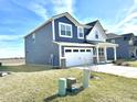 Side view of a modern two-story home with a well-kept lawn and a two-car garage at 8626 Jeff Cir, Brownsburg, IN 46112