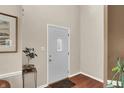 Bright entryway featuring a white front door with glass insert, wood floors, and neutral wall paint at 9243 Crossing Dr, Fishers, IN 46037