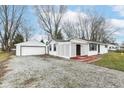 Charming single story home with detached garage, white siding, covered porch and gravel driveway at 9923 N 125 W, Fortville, IN 46040