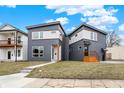 Modern two-story home with eye-catching architectural design, gray siding, and an inviting front yard at 1024 Calvary St, Indianapolis, IN 46203