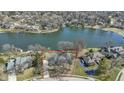 Aerial view of lakeside property outlined in red with mature trees and surrounding neighborhood at 10817 Lakeview Dr, Carmel, IN 46033