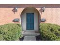Beautiful condo entrance featuring a teal-colored door and an arched brick entryway at 1138 Canterbury S Sq, Indianapolis, IN 46260
