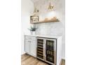 Stylish bar area boasts a beverage fridge, ample counter space, and decorative tile backsplash at 13770 Marylou Dr, Carmel, IN 46074