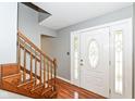 Inviting entryway with hardwood floors, a staircase, and a beautifully designed front door with decorative glass at 14485 Oak Ridge Rd, Carmel, IN 46032