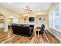 Cozy living room features wood floors, a fireplace, and arched doorway to dining room at 15506 Slateford Rd, Noblesville, IN 46062