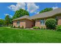 Beautiful brick home with a lush green lawn, manicured landscaping, and a welcoming exterior at 1738 Pathway S Dr, Greenwood, IN 46143