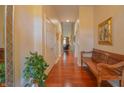 Hallway with beautiful hardwood floors, decorative mirror, wooden bench, and neutral paint at 1738 Pathway S Dr, Greenwood, IN 46143
