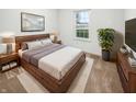 Inviting bedroom featuring modern wood furniture, a plush rug, and a large window for natural light at 1914 Kingen Dr, Greenfield, IN 46140