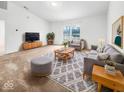 Bright living room with neutral tones, plush rug, and ample seating for comfortable relaxation at 1914 Kingen Dr, Greenfield, IN 46140