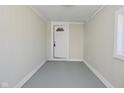 Enclosed entryway with white walls, gray floors, and a door to the outside at 207 E Wall St, Advance, IN 46102