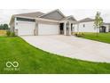 Charming single-story home showcasing a three-car garage, a covered porch, and a well-manicured lawn at 2254 Oakmont Dr, Plainfield, IN 46168