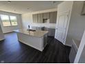 Modern kitchen featuring an island with a sink, stylish cabinets and a sleek countertop under recessed lighting at 2254 Oakmont Dr, Plainfield, IN 46168