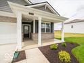 Inviting covered porch framed by classic columns and landscaping at 2254 Oakmont Dr, Plainfield, IN 46168