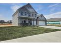 Attractive two-story home with a 2-car garage, manicured lawn, and a modern design at 2260 Oakmont Dr, Plainfield, IN 46168