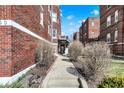 Exterior view of apartment building entrance, showcasing well-kept landscaping at 230 E 9Th St # Apt 405, Indianapolis, IN 46204