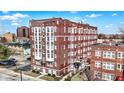 Brick apartment building with traditional design, landscaped grounds, and surrounding urban cityscape at 230 E 9Th St # Apt 405, Indianapolis, IN 46204