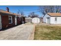 Backyard with a detached garage, shed, and fenced yard at 2317 Courtney Rd, Indianapolis, IN 46219
