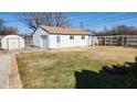 Spacious backyard featuring a detached garage, shed, and fenced perimeter at 2317 Courtney Rd, Indianapolis, IN 46219