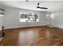 Bright living room featuring hardwood floors, recessed lights and a large window for natural light at 3025 E 6Th St, Anderson, IN 46012