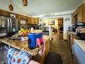 Open kitchen featuring granite countertops, stainless steel appliances and natural wood cabinets at 3066 Falcon Dr, Indianapolis, IN 46222
