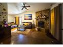 Cozy living room with a stone fireplace, comfortable seating, and natural light, perfect for relaxation at 3066 Falcon Dr, Indianapolis, IN 46222