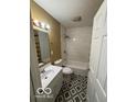 Bright bathroom features tiled walls, stylish flooring, and modern fixtures and shower-tub combo at 3302 E 42Nd St, Indianapolis, IN 46205
