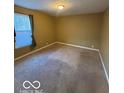 Sunny bedroom showcasing a window, freshly painted walls and neutral carpet at 3302 E 42Nd St, Indianapolis, IN 46205