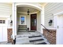 Inviting front porch with bench seating, stylish lighting, and brick accents at 3331 Adare Cir, Westfield, IN 46062