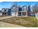 Two-story home with blue siding and a two-car garage, with a tree in the front yard at 3602 Shepperton Blvd, Indianapolis, IN 46228