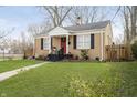 Inviting single-story home showcasing a well-maintained lawn and charming front entrance with black steps at 4035 N Kenwood Ave, Indianapolis, IN 46208