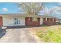 Brick and siding home with a grassy front yard and visible driveway at 4113 Gambel Rd, Indianapolis, IN 46221