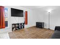 Bright living room with light walls, a brown grid pattern rug, and minimalist furniture at 4307 Dahlia Ct, Indianapolis, IN 46220