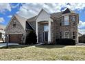 Two-story brick home with a two-car garage and a turret on a sunny day at 4309 Worchester Ct, Carmel, IN 46033