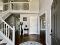 Bright foyer with hardwood floors, an open staircase and gray painted walls at 4309 Worchester Ct, Carmel, IN 46033